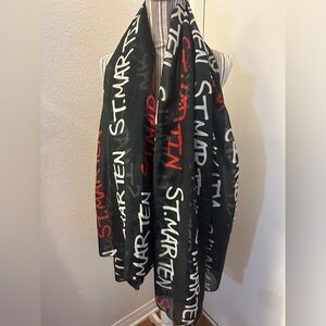 Black scarf with red and white writing ￼